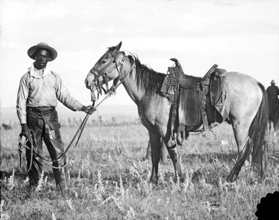 Black cowboy and horse, c.1890-1920 by American Photographer